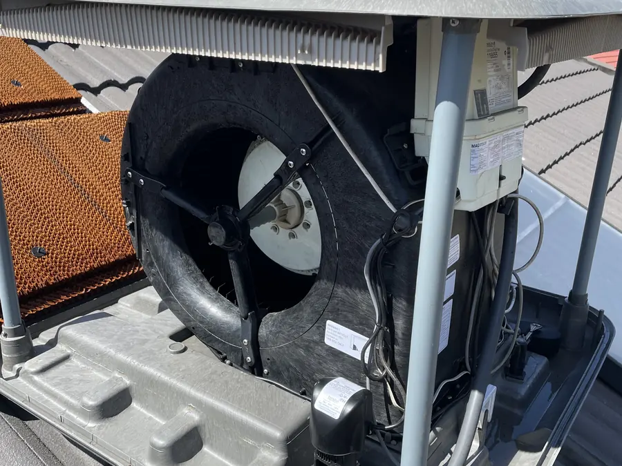 Evaporative cooling unit opened up for servicing on a Melbourne rooftop